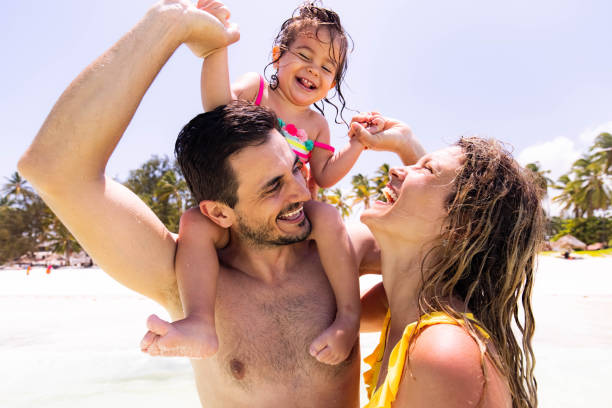 istock Cheerful family having fun during summer day on the beach. 1340414809