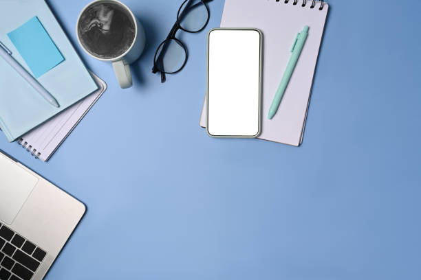 istock Mock up smart phone, laptop, coffee cup and coffee cup on blue background. 1340415972