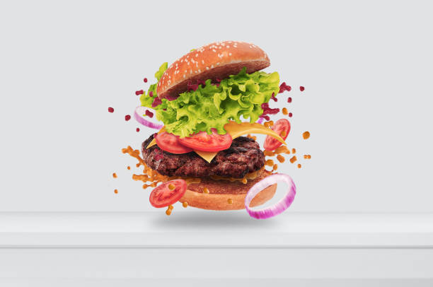 delizioso hamburger volante in cucina bianca - veggie burger foto e immagini stock