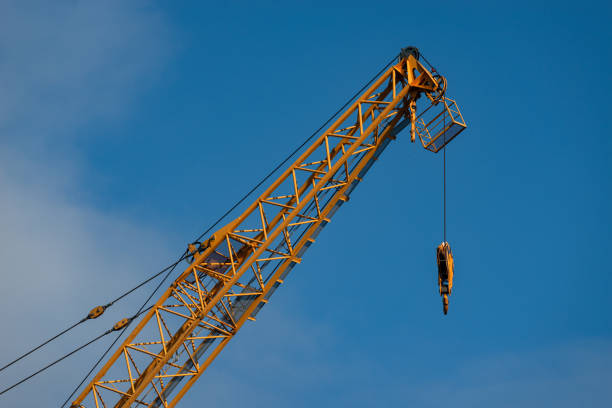 Industrial construction crane against the blue sky