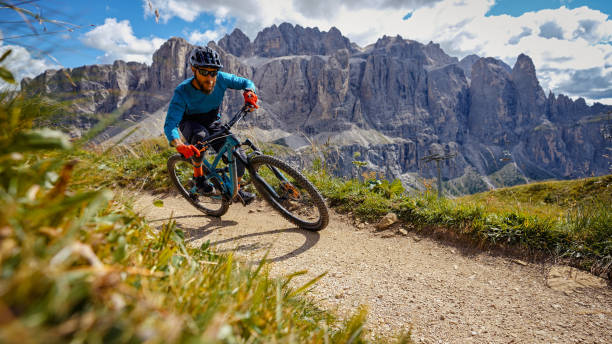 MTB mountain biking outdoor on the Dolomites:enduro discipline over a single trail track MTB mountain biking outdoor on the Dolomites: enduro discipline over a single trail track mountain biking stock pictures, royalty-free photos & images