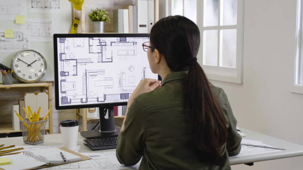 istock woman interior designer looking floor plan 1340420878