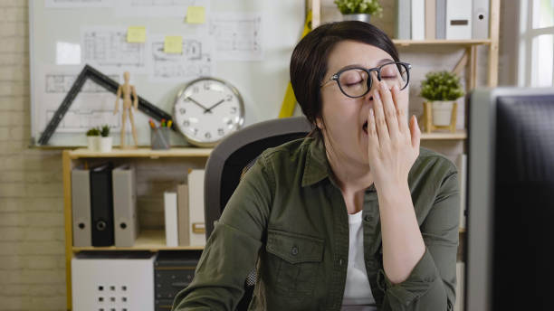 istock Tired overworked woman architect yawning 1340421041