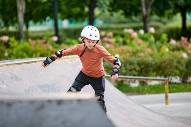 istock Little boy skateboarding in park 1340422488