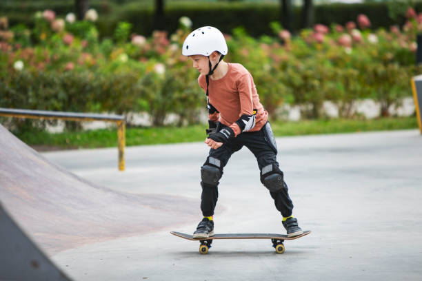 istock Little boy skateboarding in park 1340422510