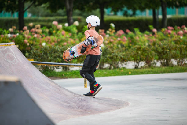 istock Little boy skateboarding in park 1340422521