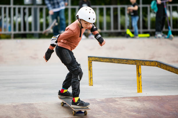 istock Little boy skateboarding in park 1340422639