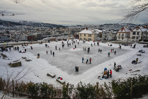People outdoors in winter: iceskating on a frozen lake in Bergen