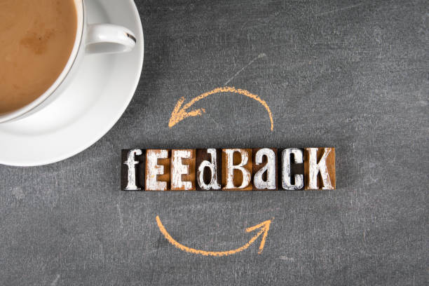 istock Feedback concept. Text from wooden letters and a coffee cup on a black chalk board 1340424560