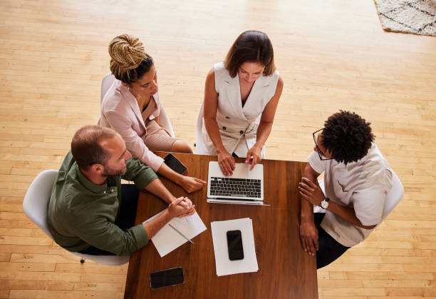 istock Diverse businesspeople working together at a table in an office 1340425489