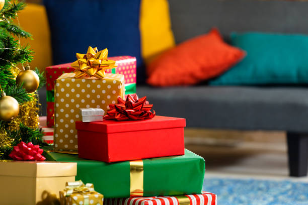 istock Composition of christmas tree and stacked presents on blurred background 1340425797