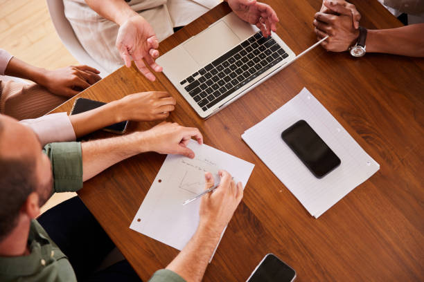 istock Diverse businesspeople working together around a table in an office 1340426342