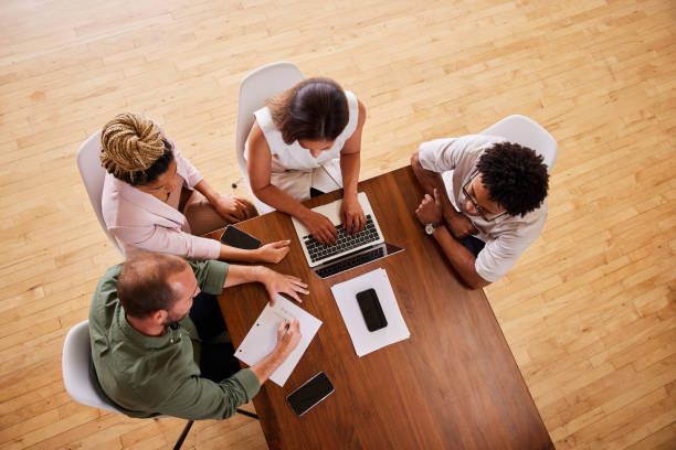 istock Group of diverse businesspeople working around an office table 1340427442