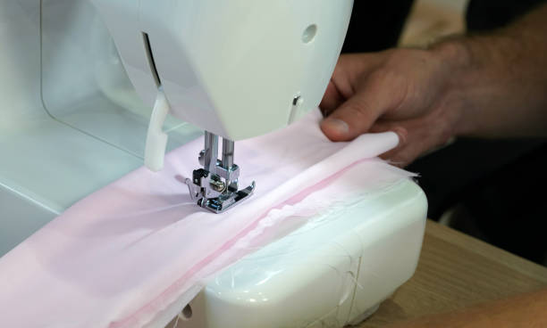 istock The dressmaker elaborately made  thread pattern on a fine pink fabric. 1340427850