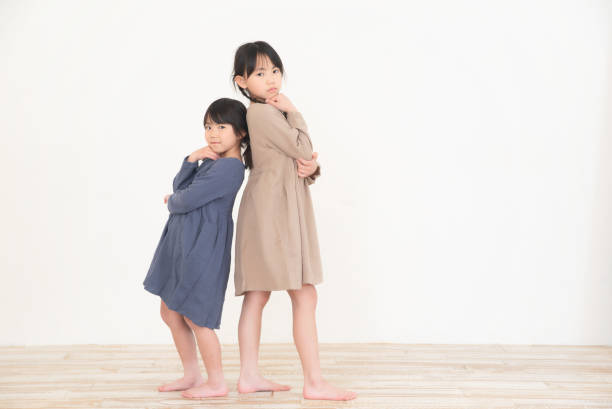 istock Little sisters in matching clothes 1340428121