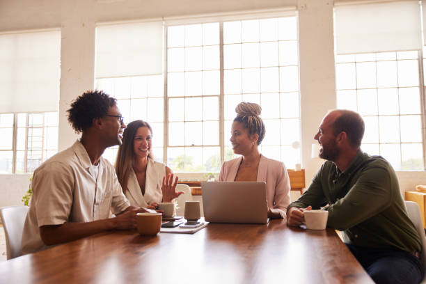 istock Smiling businesspeople talking during a meeting at an office table 1340430854