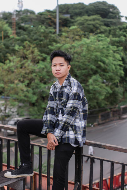 istock Young men relaxing at rooftop park city 1340431207
