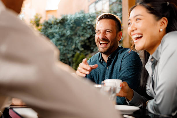 istock Cheerful business colleagues talking in a cafe. 1340432620