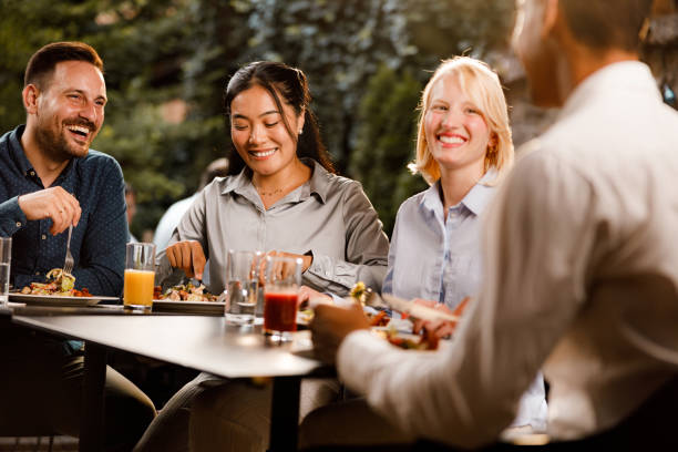 istock Happy business colleagues talking on a lunch in a restaurant. 1340433136