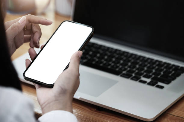 istock Woman hand holding smartphone  Blank screen mobile phone for graphic display montage. 1340433754