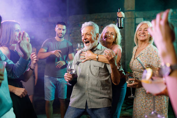 istock Carefree seniors having fun among young people in a disco. 1340434754