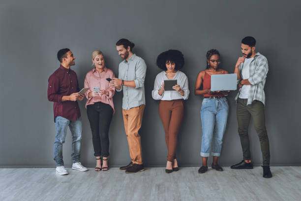 istock Studio shot of a diverse group of people using digital devices against a grey background 1340434802