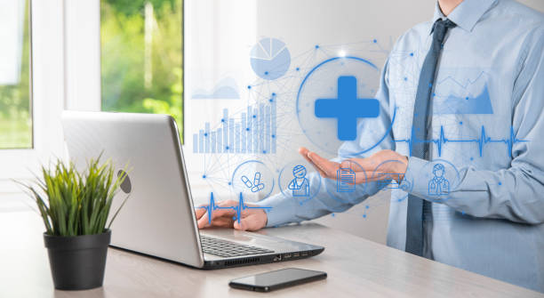 istock Businessman hold virtual plus medical network connection icons. Covid-19 pandemic develop people awareness and spread attention on their healthcare.Doctor,document,medicine,ambulance,patient icon. 1340435158