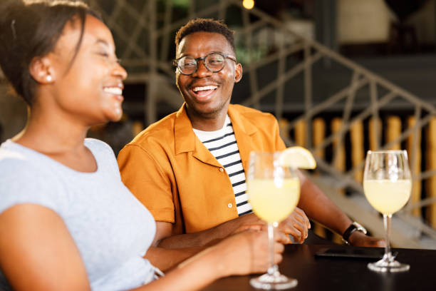 istock Happy African American couple talking in a cafe. 1340435351