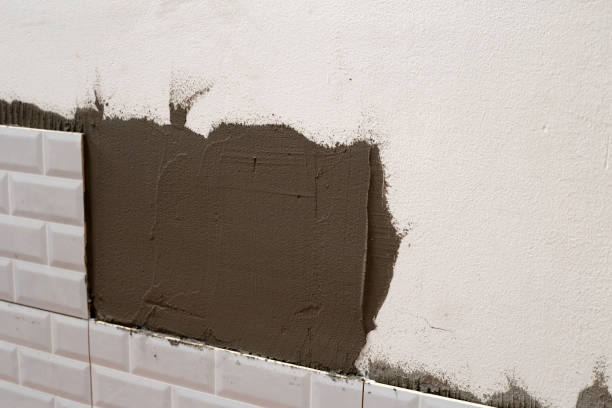 istock House renovation, Laying ceramic tles on the wall. 1340435354