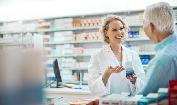 Cropped shot of an attractive young chemist helping a senior male customer in her pharmacy You should notice an immediate change chemist stock pictures, royalty-free photos & images