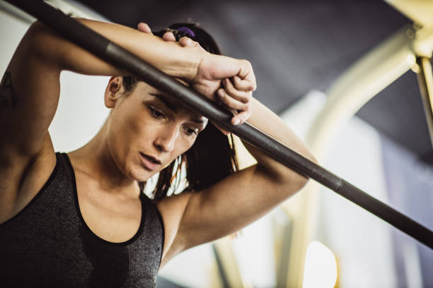 istock Tired female athlete taking a break in a gym. 1340436687