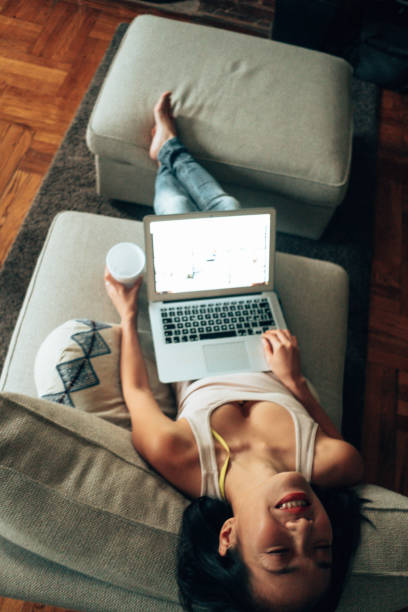 istock working at home lying down in the bed with laptop 1340438712