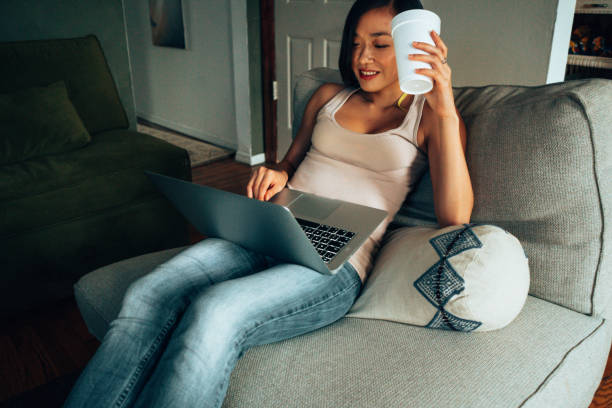 istock working at home lying down in the bed with laptop 1340439070