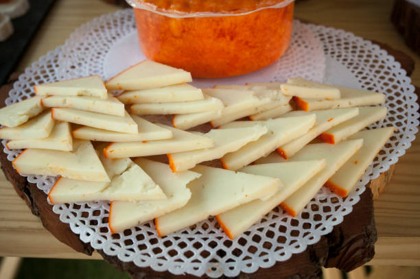 Half-cured smoked paprika cheese slices arrangement. Closeup