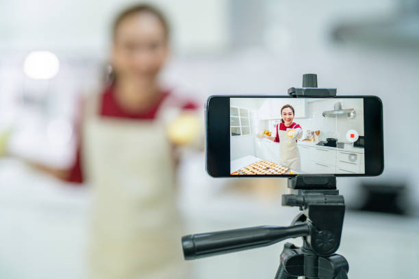 istock Asian woman using smartphone with internet advertising her bakery class on social media 1340440874