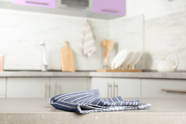 istock Striped cotton towel on light grey table in kitchen 1340441026