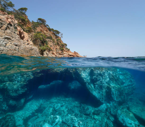 costa rochosa e rocha com buraco no mar subaquático - below sea level - fotografias e filmes do acervo