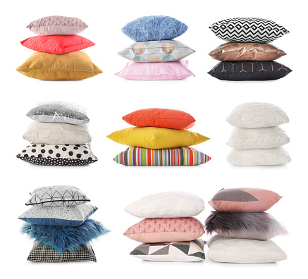 Set of different stacked pillows on white background