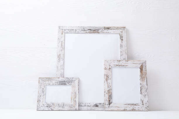 istock Composition of white cards in distressed white frames with copy space on white background 1340443735