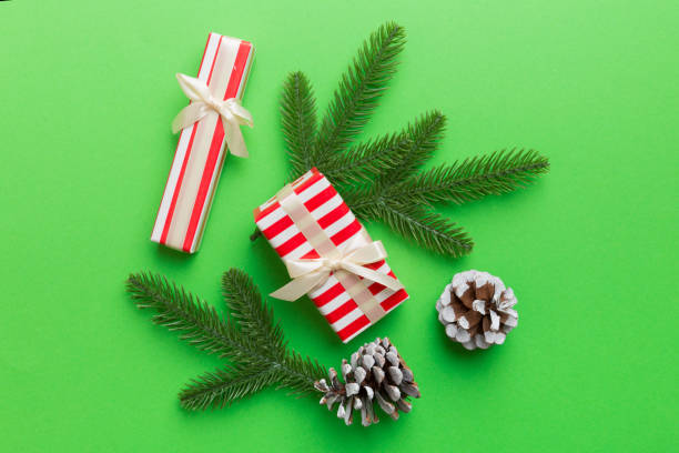 istock Christmas decorations and fir tree branch and gift boxon dark table. Top view frame with copy space 1340443944