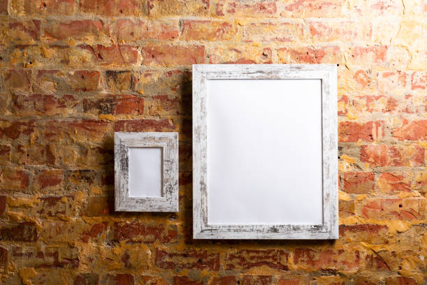 istock Composition of white cards in frames with copy space and decorations on brick wall 1340444490