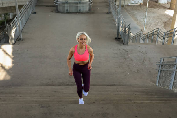 istock Senior athletic woman jogging upstairs 1340444833