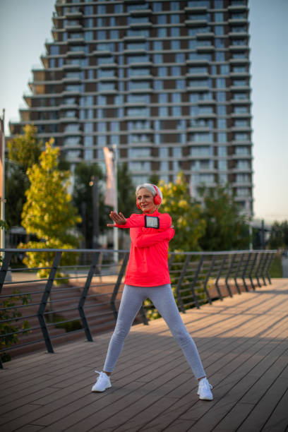 istock Senior athletic woman stretching outside 1340444886