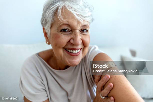 Elderly Lady Getting Immunization Via Antiviral Vaccine Stock Photo - Download Image Now