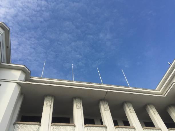 istock The flagpole is stuck on top of a tall white building. 1340446464