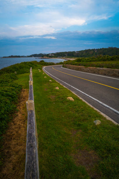 istock Moody coastal road with dramatic clouds on Cape Cod in the summer 1340446577
