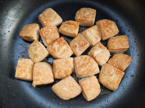 istock Frying Tofu in cooking pan. 1340447059