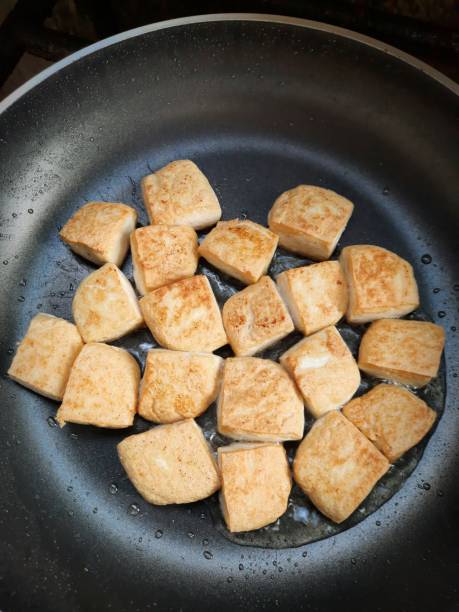 istock Frying Tofu in cooking pan. 1340447066