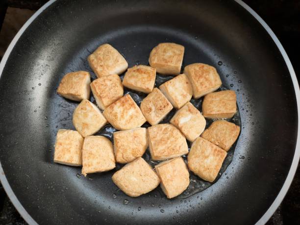 istock Frying Tofu in cooking pan. 1340447068