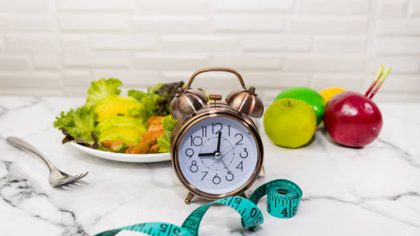 Intermittent Fasting for Busy Professionals 1 breakfast in the morning with alarm clock diet program plan in intermittent fasting concept